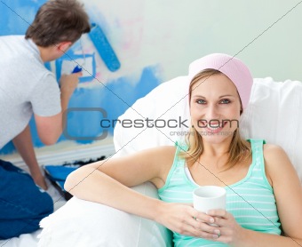 Relaxing smiling woman sitting on the sofa