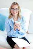 Charismatic businesswoman holding cup wearing glasses 