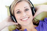 Portrait of smiling woman  listening music looking at the camera