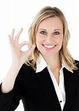 Confident young  businesswoman showing OK sign 