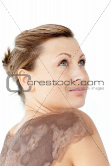 Relaxed woman liking a mud skin treatment in a Spa center