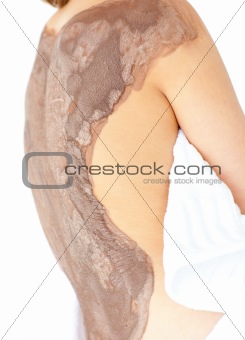 Close-up of a woman enjoying a mud skin treatment