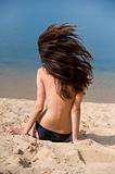 beautiful brunette on  beach sunbathes