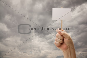 Man Holding Blank Sign Over Dramatic Storm Cloudy Sky - Ready For Your Own Message on Sign and Over Clouds.