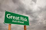 Great Risk Just Ahead Green Road Sign with Dramatic Storm Clouds and Sky.