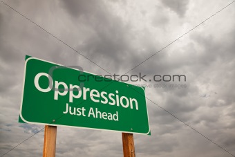 Oppression Just Ahead Green Road Sign with Dramatic Storm Clouds and Sky.