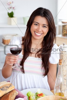 Good-looking woman sitting on sofa and drinking 