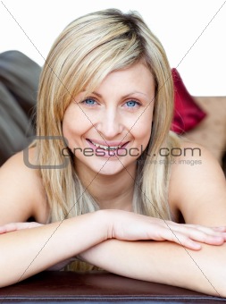 Cute woman lies on a brown sofa