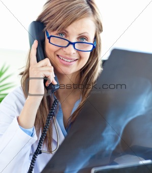 Beautiful female doctor with glasses sitting in office 