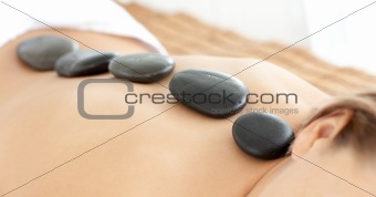 Close-up of a woman with hot stones on her back 