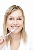 Portrait of a pretty woman brushing her teeth