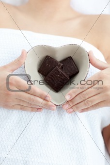 Close-up of a woman holding a bowl in the shape of a heart with 