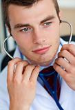 Portrait of an assertive male doctor holding a stethoscope