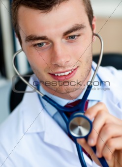Charming young doctor examining with a stethoscope 