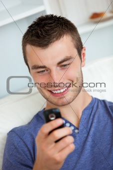 Attractive man writing a message 