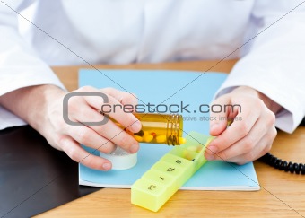 Close-up of a doctor giving pills to a patient 