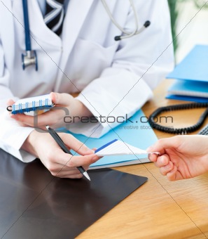 A doctor giving his patient a prescription