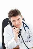 Handsome male doctor talking on the phone 