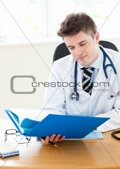 male doctor working at a computer against a white background