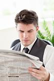 Concentrated businessman reading a newspaper