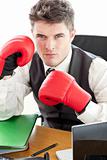 Angry businessman wearing boxing gloves 