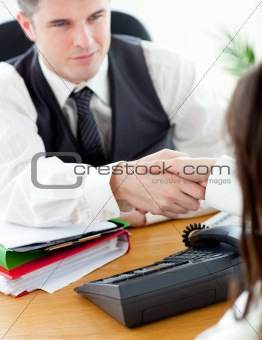 Handsome businessman closing a deal with handshake