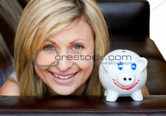 Portrait of a handsome woman with a piggybank