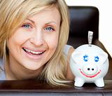 Laughing woman with a piggy bank