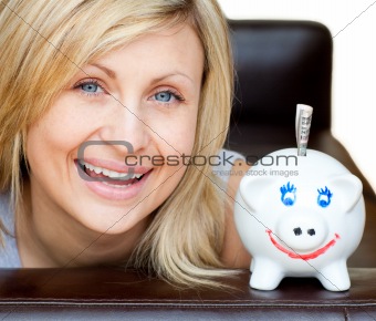 Laughing woman with a piggy bank