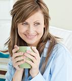 Beautiful woman holding a cup looking to the side
