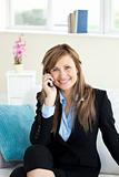 Positive businesswoman using a mobile phone i