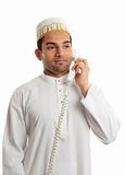Arab man wearing white robe and topi