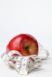 Tape measure and red apple