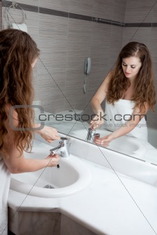 lovely woman washing hand in bathroom