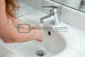 woman washing hands in bathroom