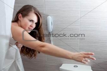 beautiful woman in bathroom streching for something