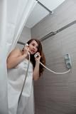 attractive woman making call in bathroom
