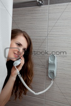 attractive woman making call in bathroom
