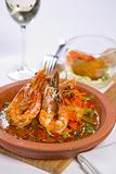 sizzling prawns with condiments and wine