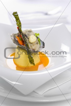 Oysters Kilpatrick served on designer plate in restaurant