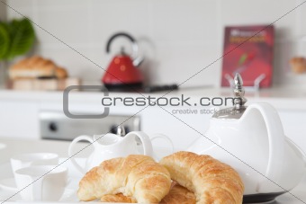 Breakfast in modern kitchen with Croissants and coffee