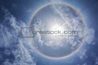 Sun with sircular rainbow and clouds