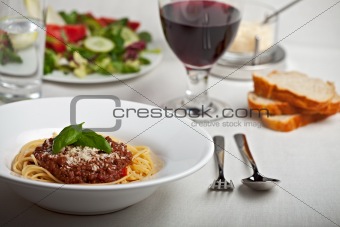 plate with spaghetti bolognese and basil leaf