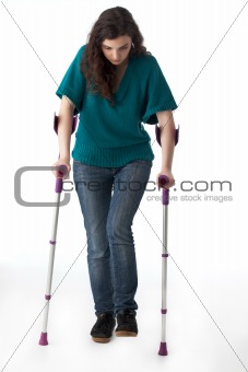 girl with crutches isolated on white