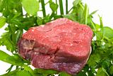 raw fillet steak on mixed herbs