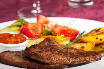 steak with ketchup and potatoes