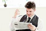 Portrait of a positive businessman reading a newspaper siiting i