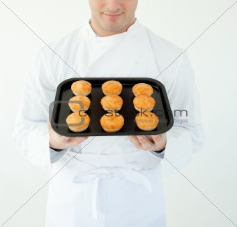 Close-up of a cook holding muffin