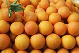 Valencia oranges stacked on market