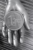 euro silver coin of futuristic metallic silver hand